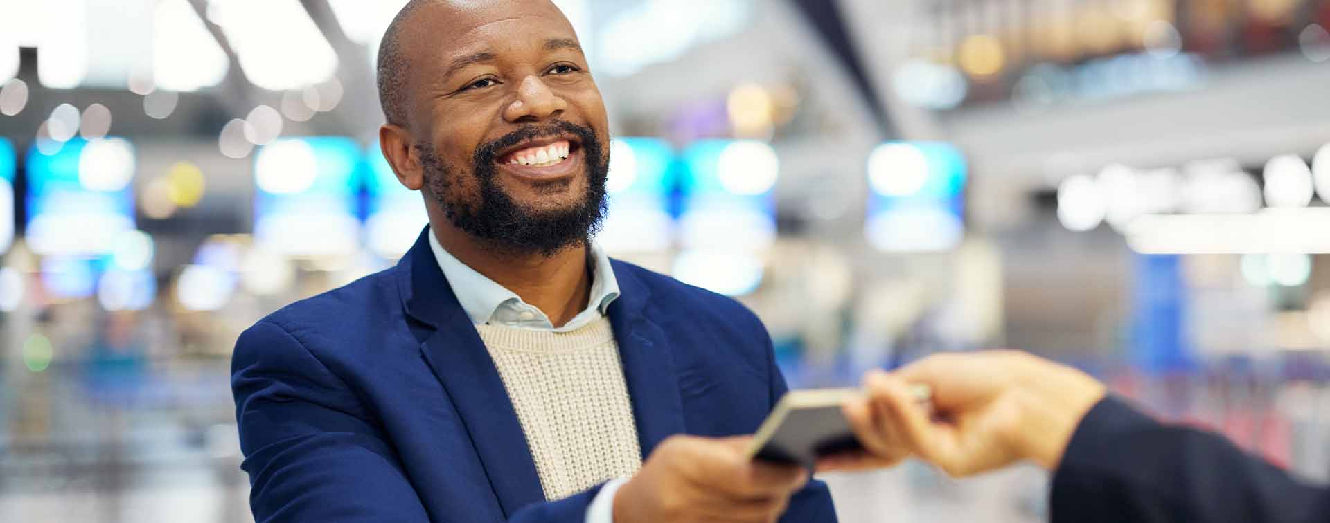 African man handing over passport before boarding his flight
