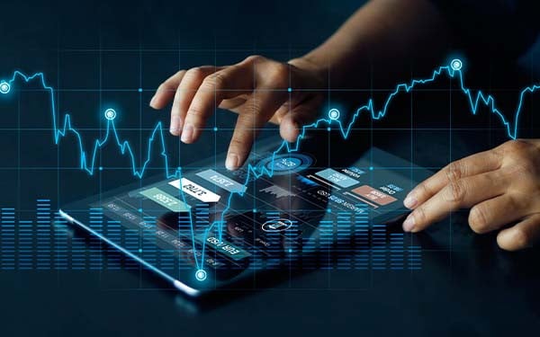 Businessman using tablet overlayed with investment graph