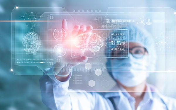 A surgeon examining a digital rendering of a human brain