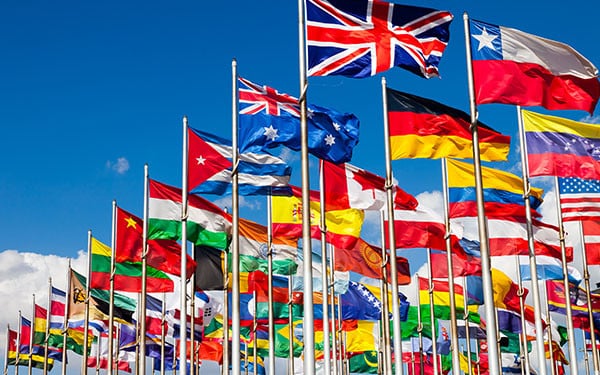 A plethora of national flags from around the world blowing in the wind