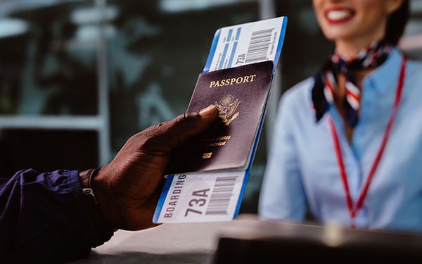 A person presenting their passport and boarding pass