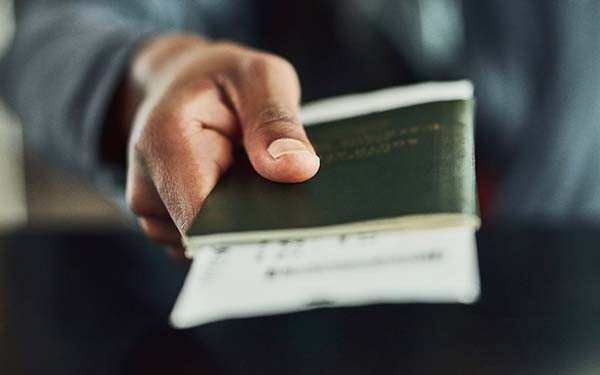 Closeup of person holding out passport