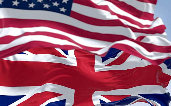 National flag of the Unites States and United Kingdom waving in the wind