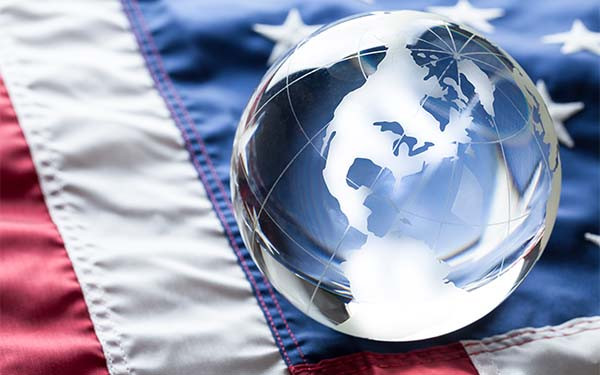 American flag on flat surface laying flat with glass globe of USA