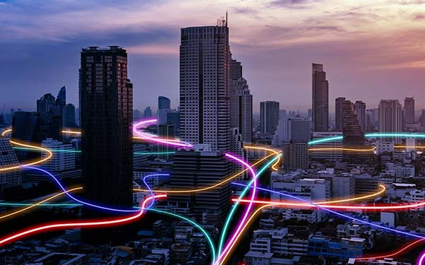 Smart city with glowing speed light trails surrounding the city
