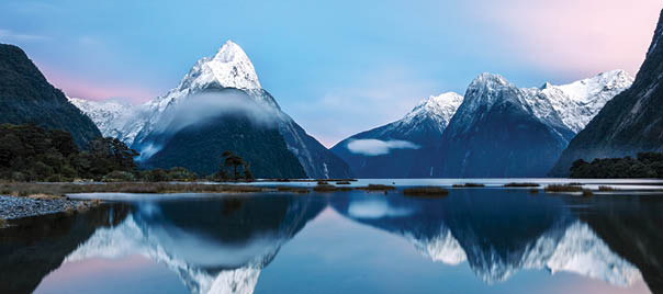 Awesome sunrise over Mitre peak and mountains of Milford Sound, Fiordland National Park, Southland, New Zealand