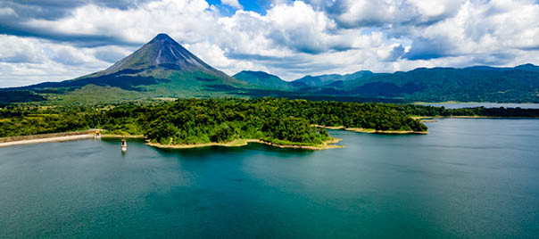 Arenal Volcano National Park in Costa Rica with Arenal Lake. The volcano is surrounded by lush tropical rainforest.